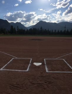 Baseball on a dark surface, with visible stitching.
