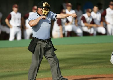 Baseball on a dark surface, with visible stitching.