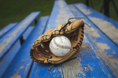 Baseball on a dark surface, with visible stitching.