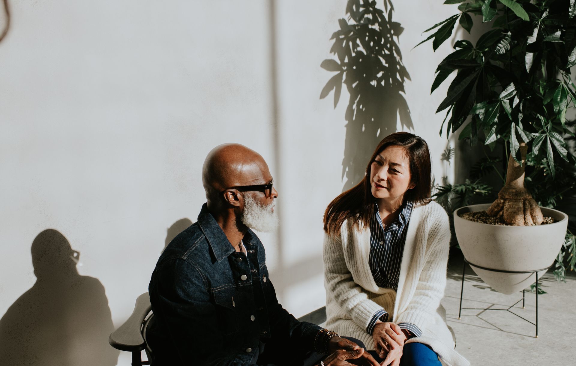 A man and a woman are sitting next to each other and talking.