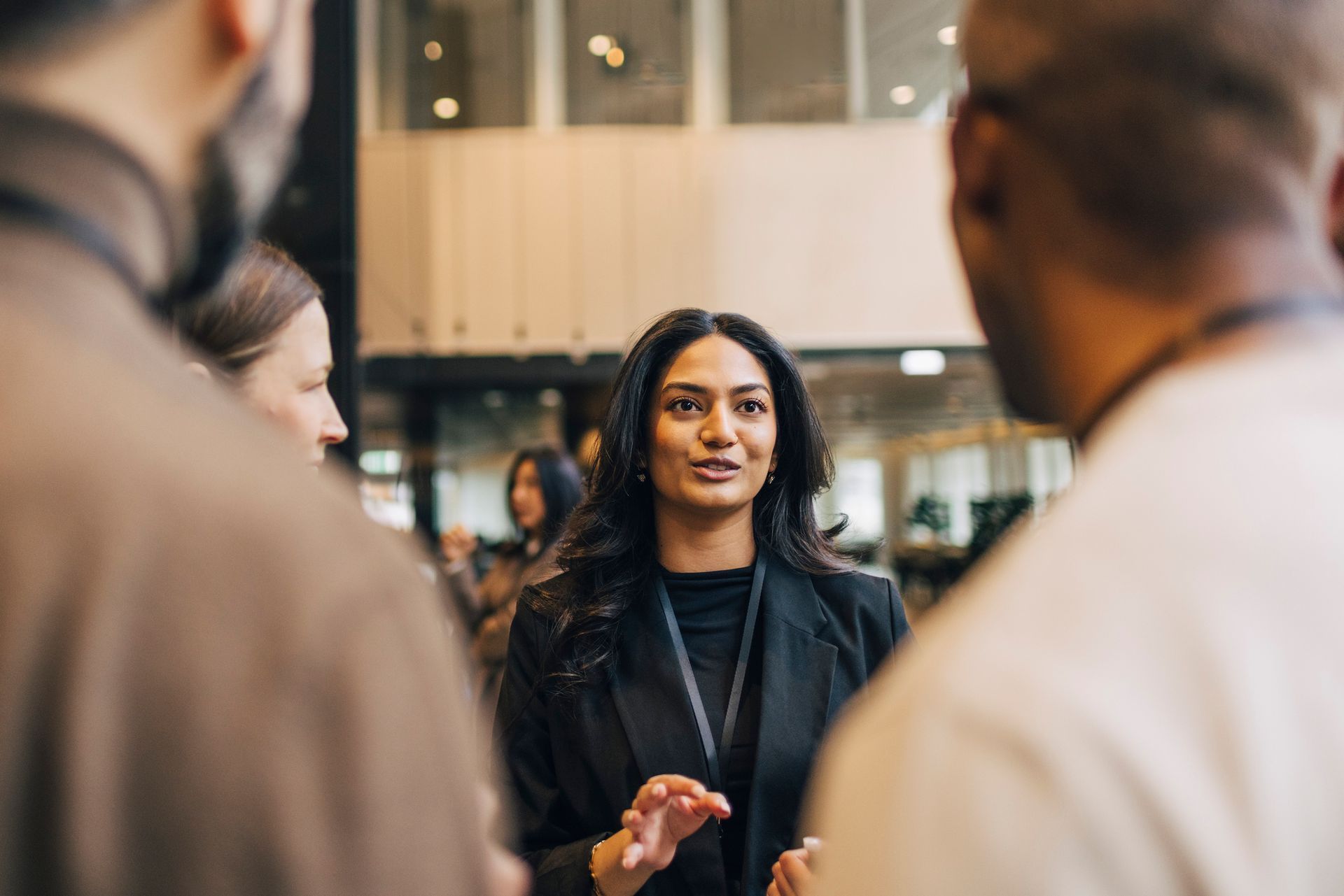 A woman is talking to a group of people in a room.