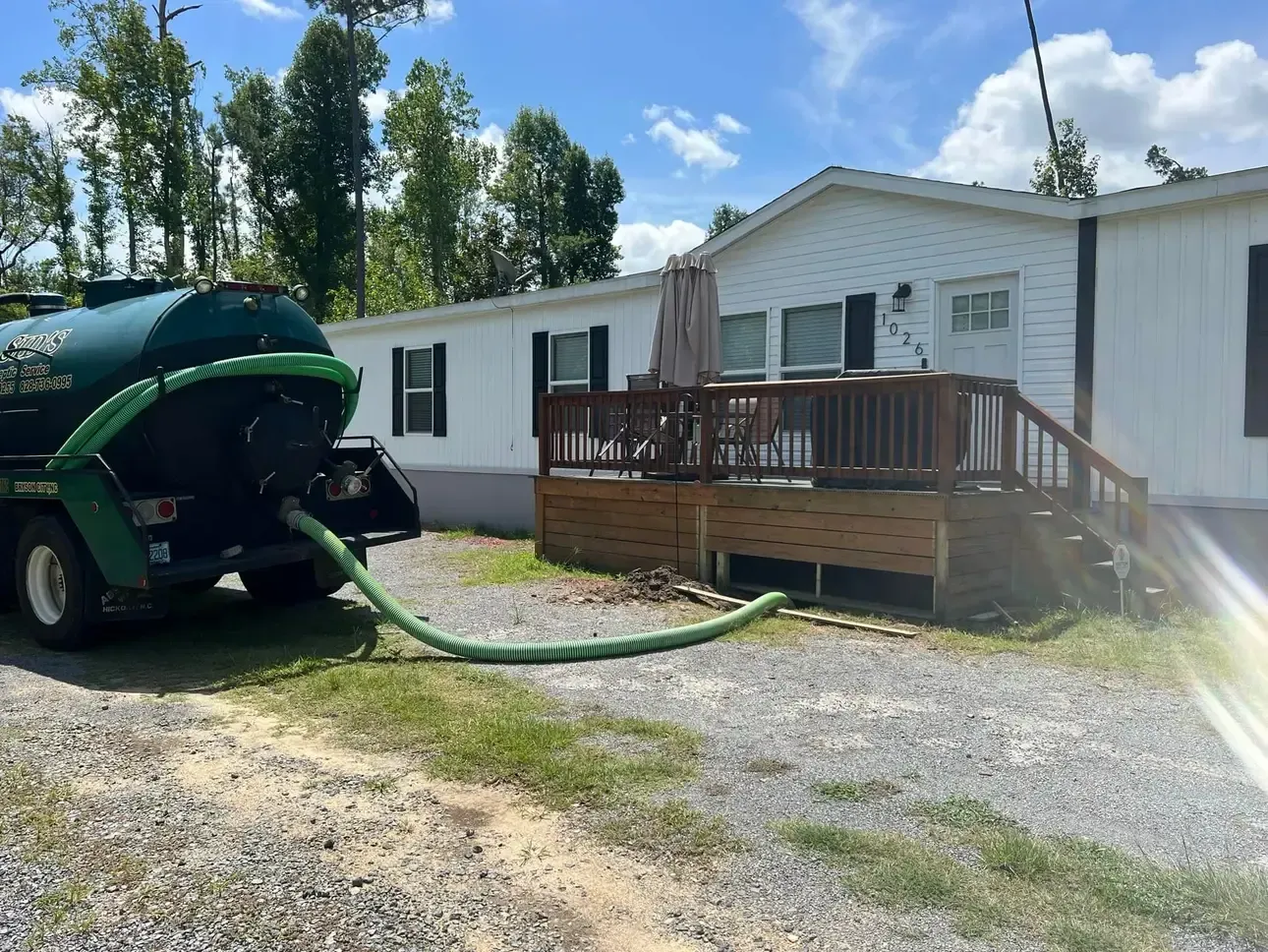 A septic tank is being pumped into a mobile home.