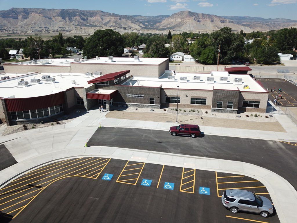 An aerial view of a school with mountains in the background