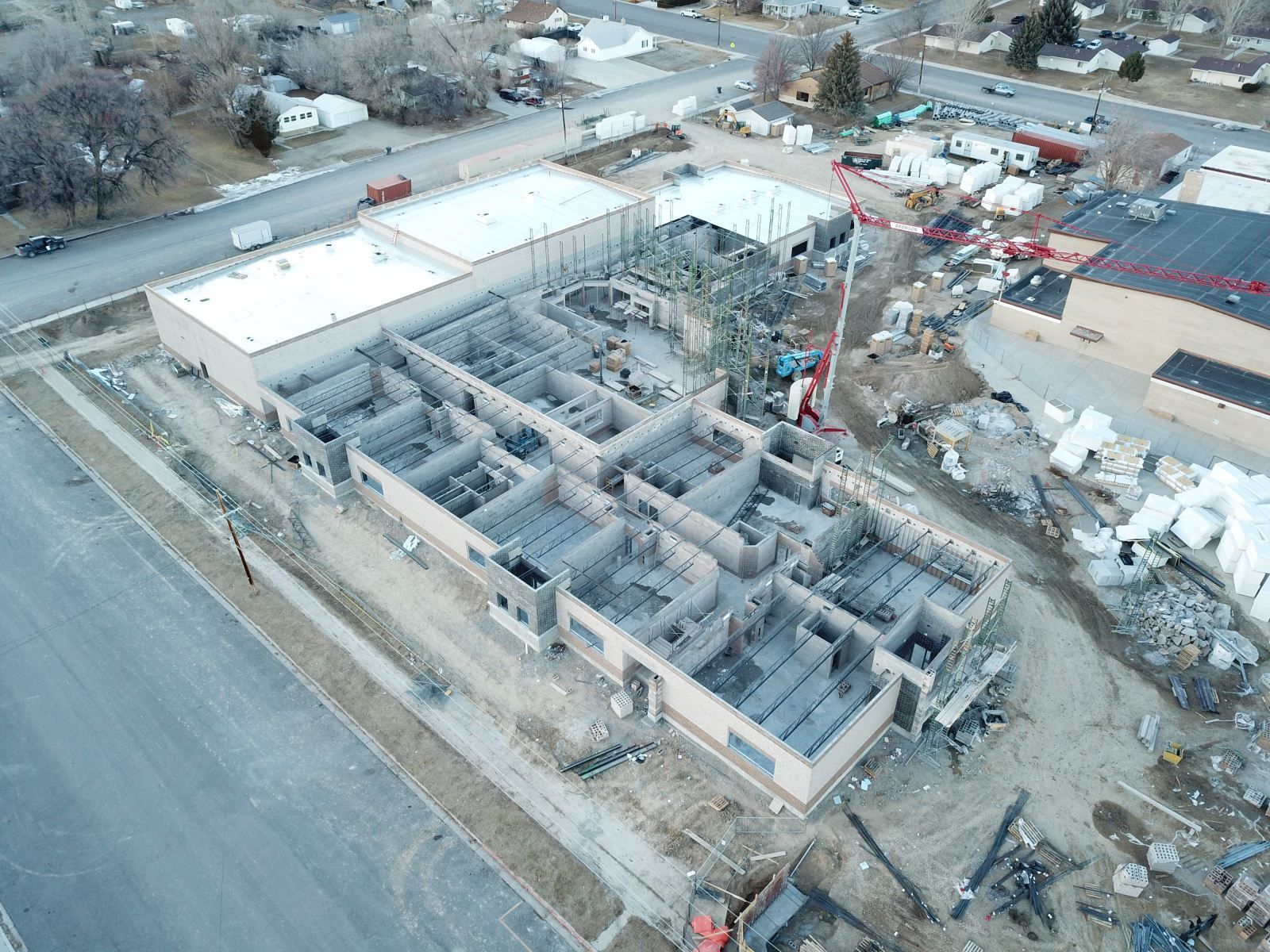 An aerial view of a building under construction in a city.