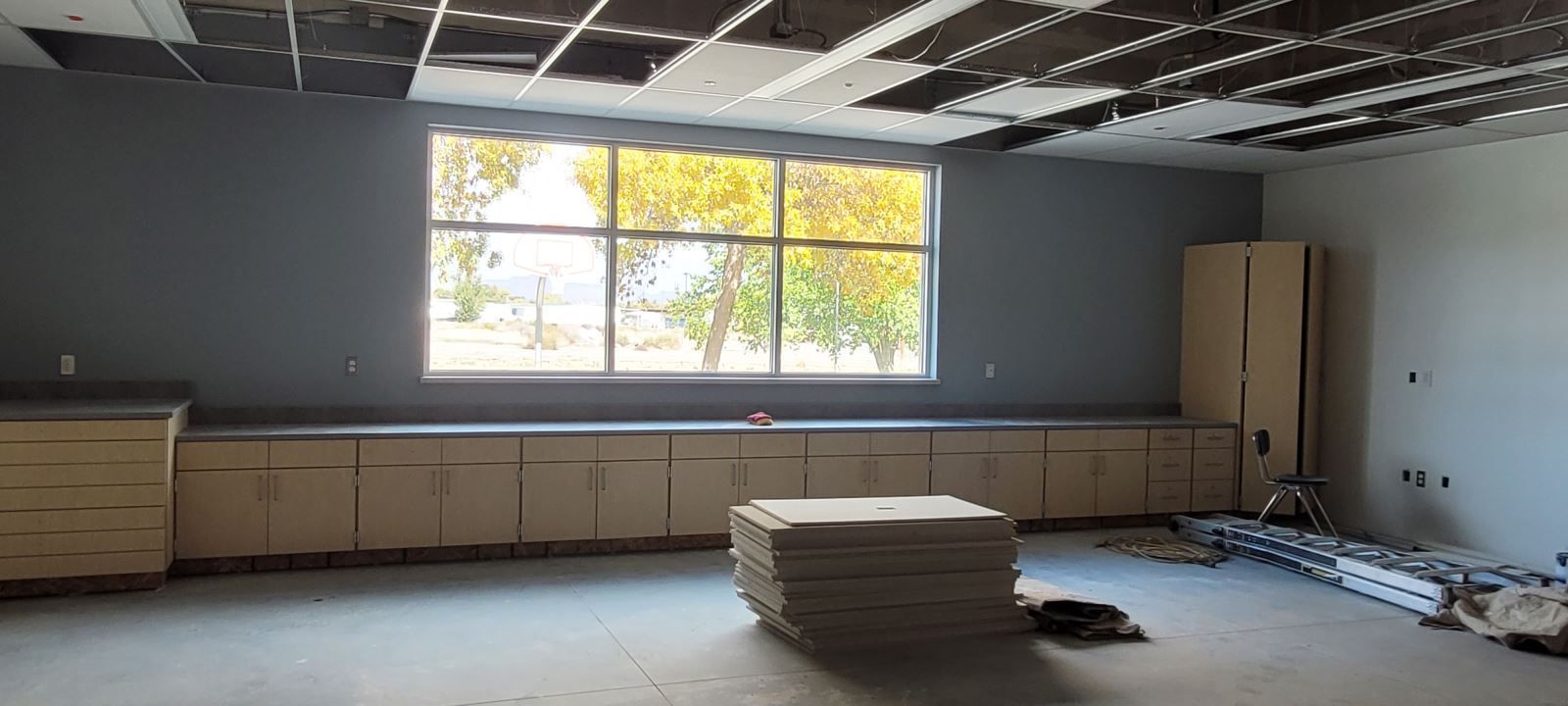 A room with a lot of cabinets and a window.