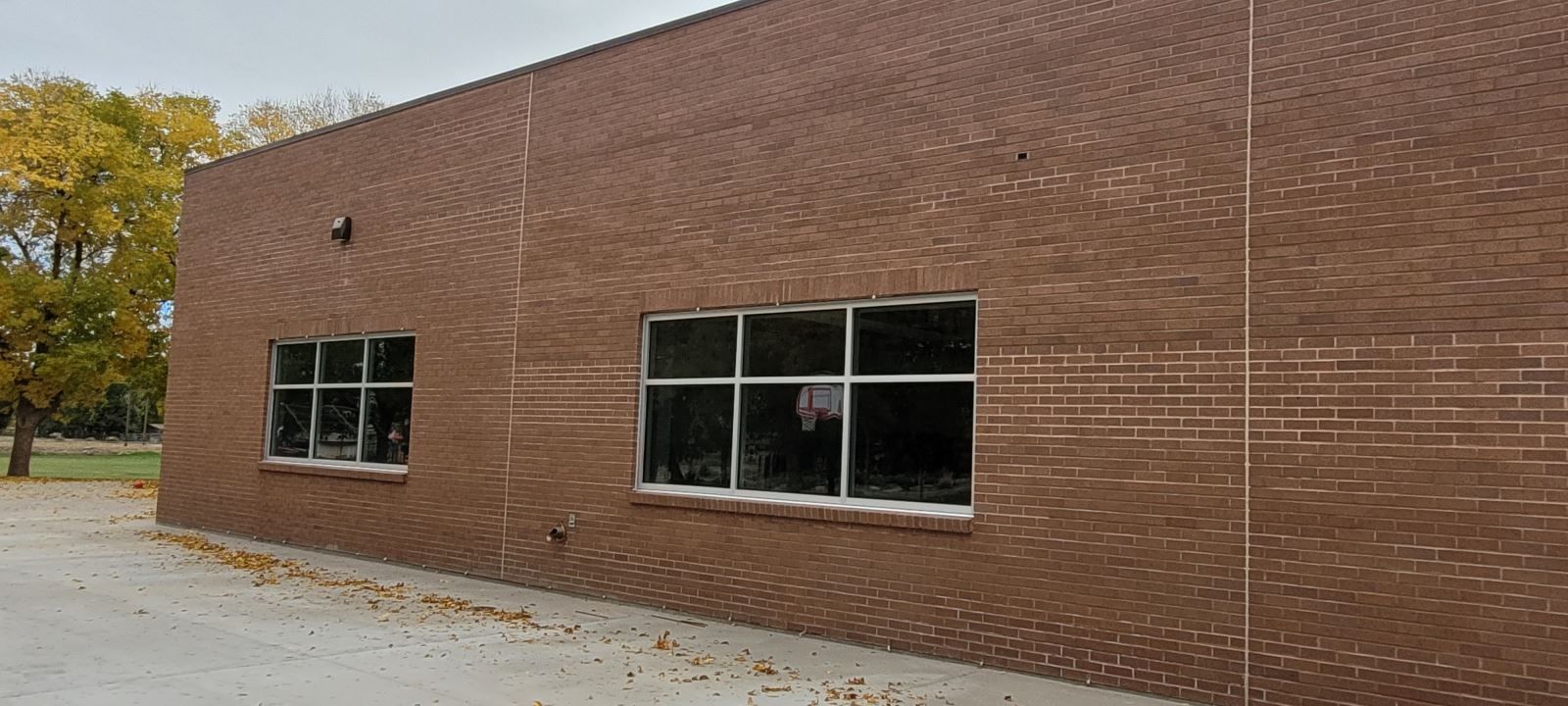 A large brown brick building with a lot of windows.