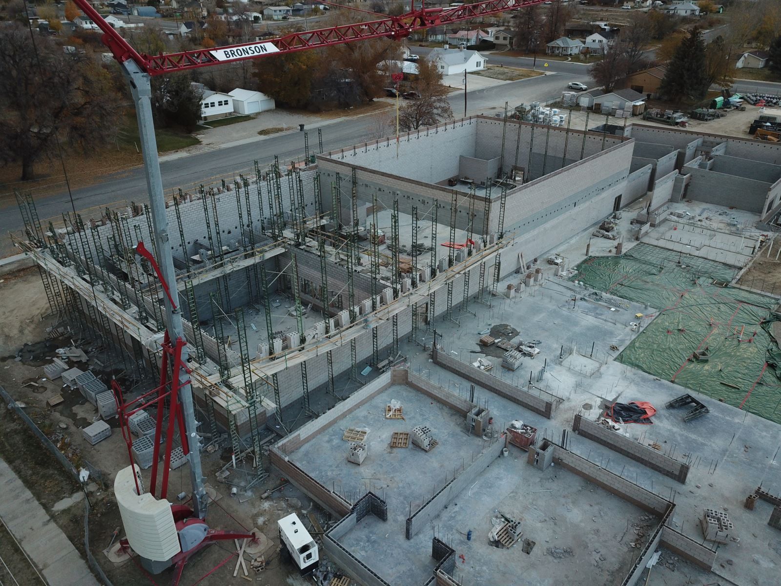An aerial view of a construction site with a crane.