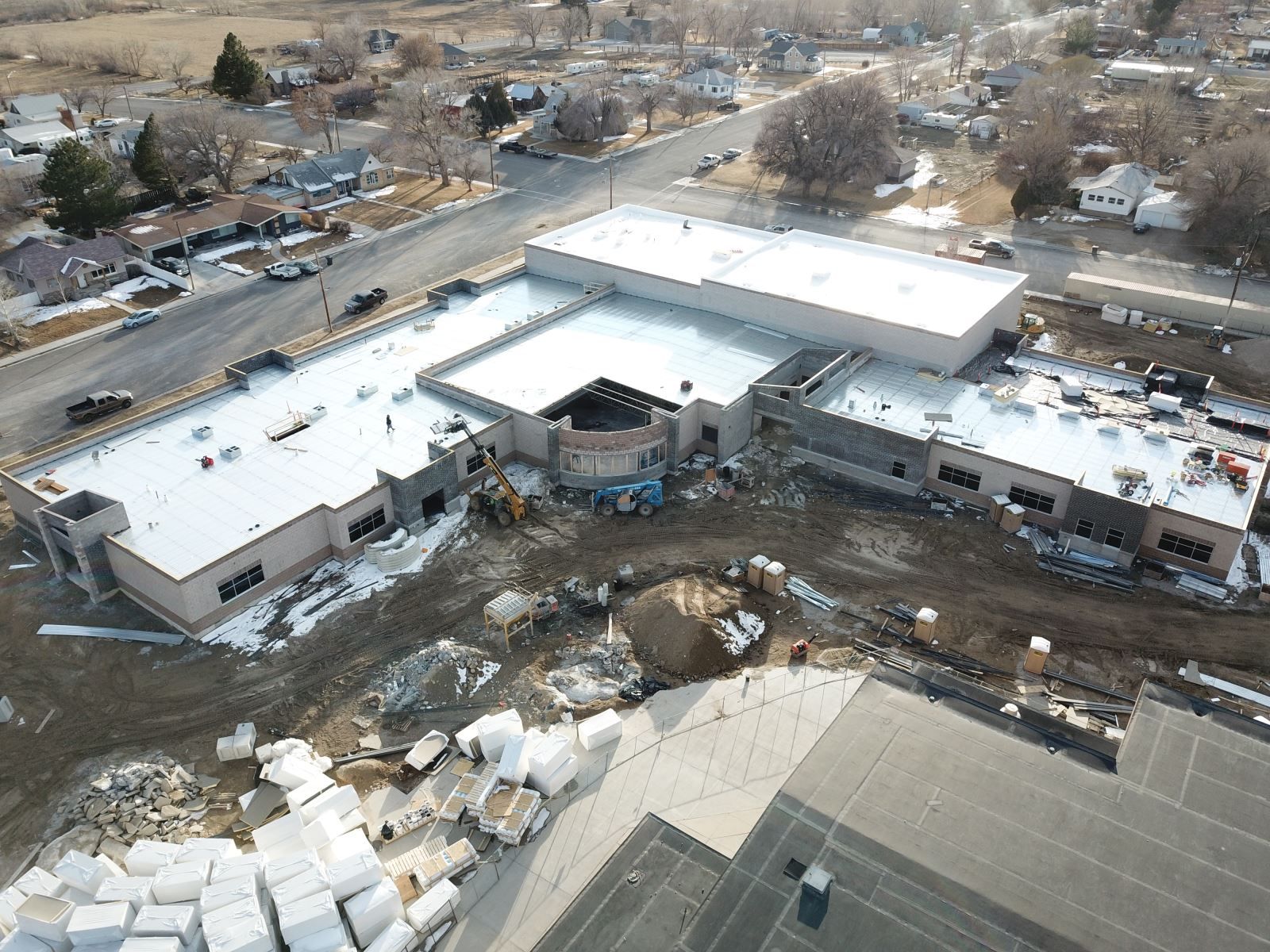 An aerial view of a building under construction in a small town.