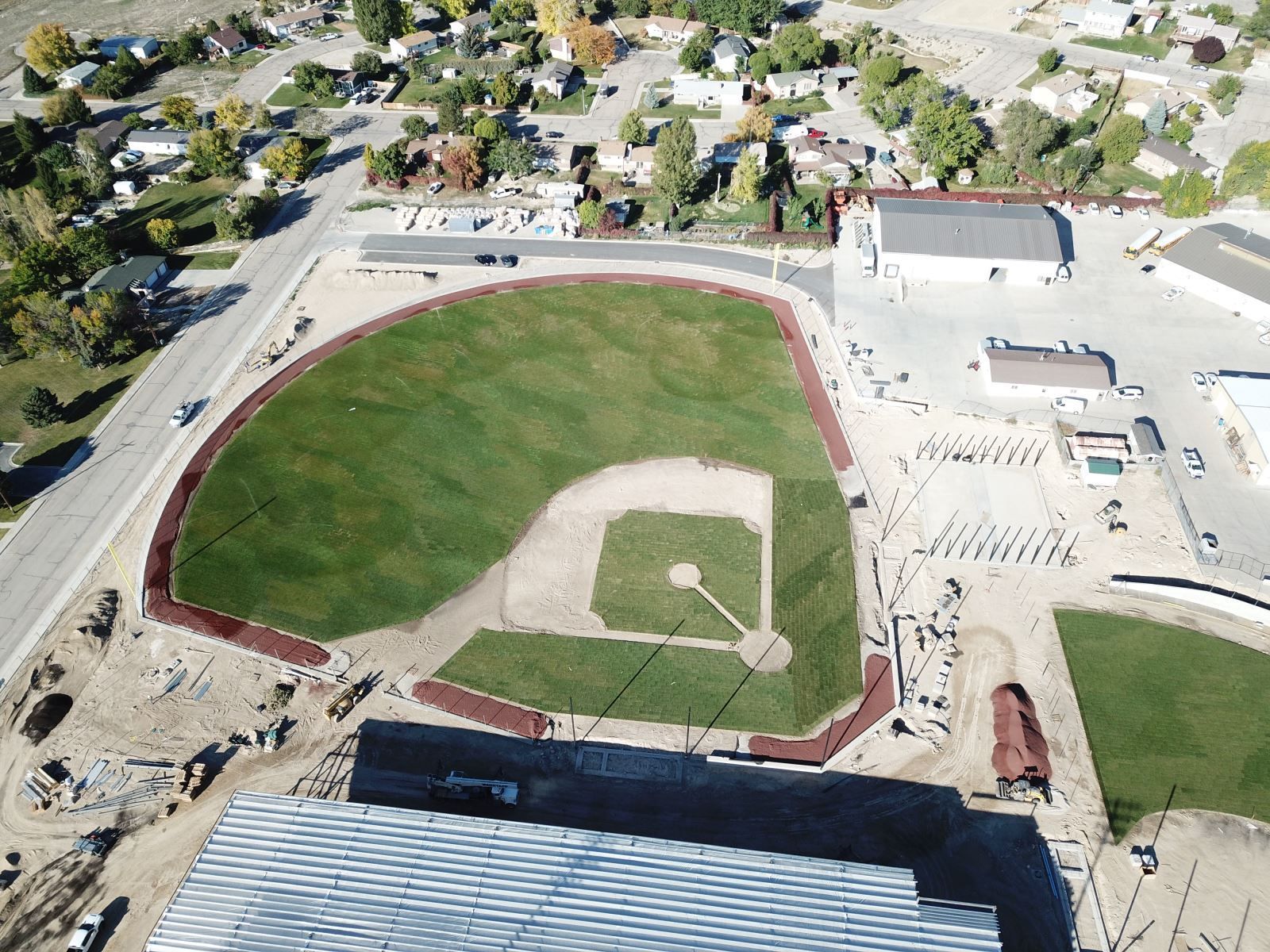 An aerial view of a baseball field in a small town