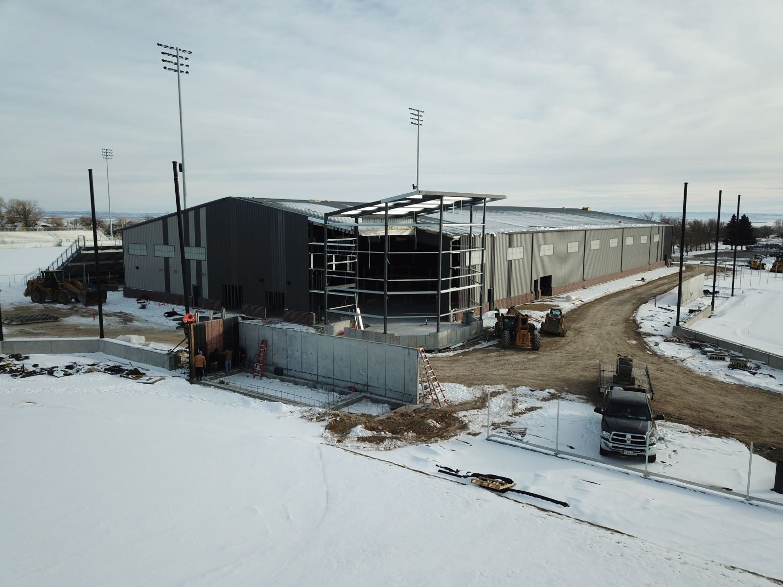 An aerial view of a building under construction in the snow.