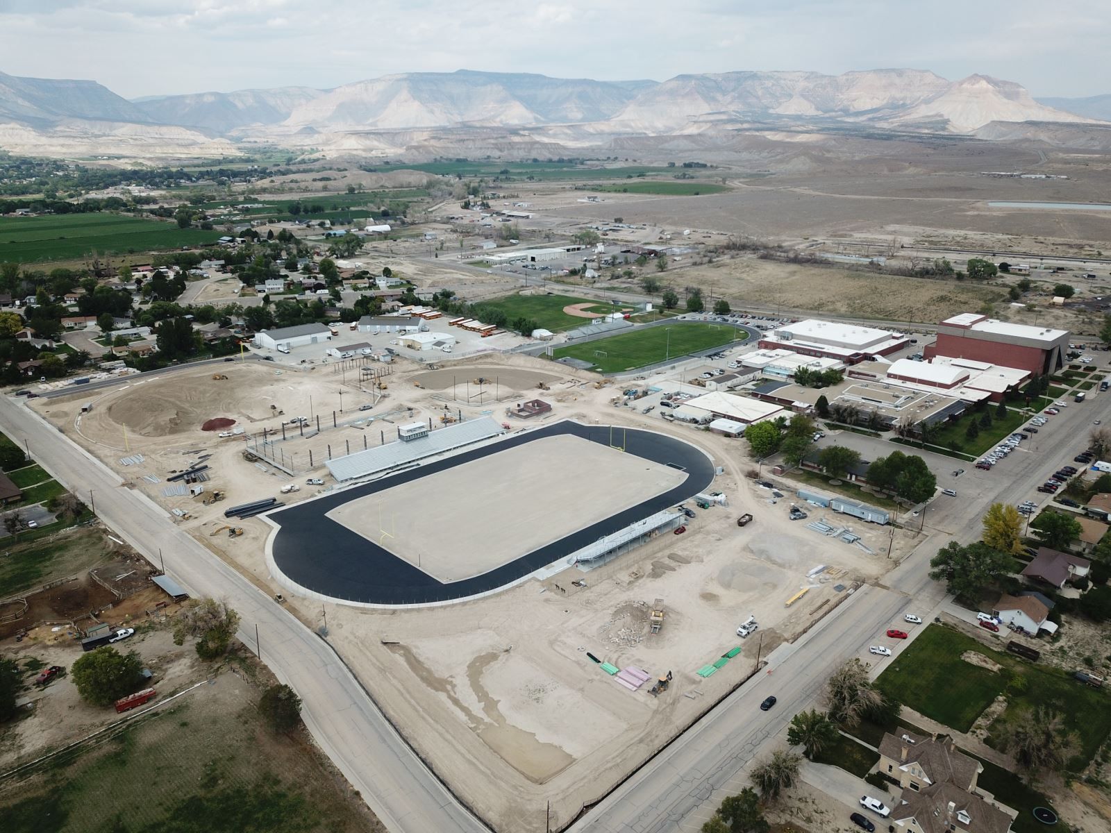 An aerial view of a large field with mountains in the background