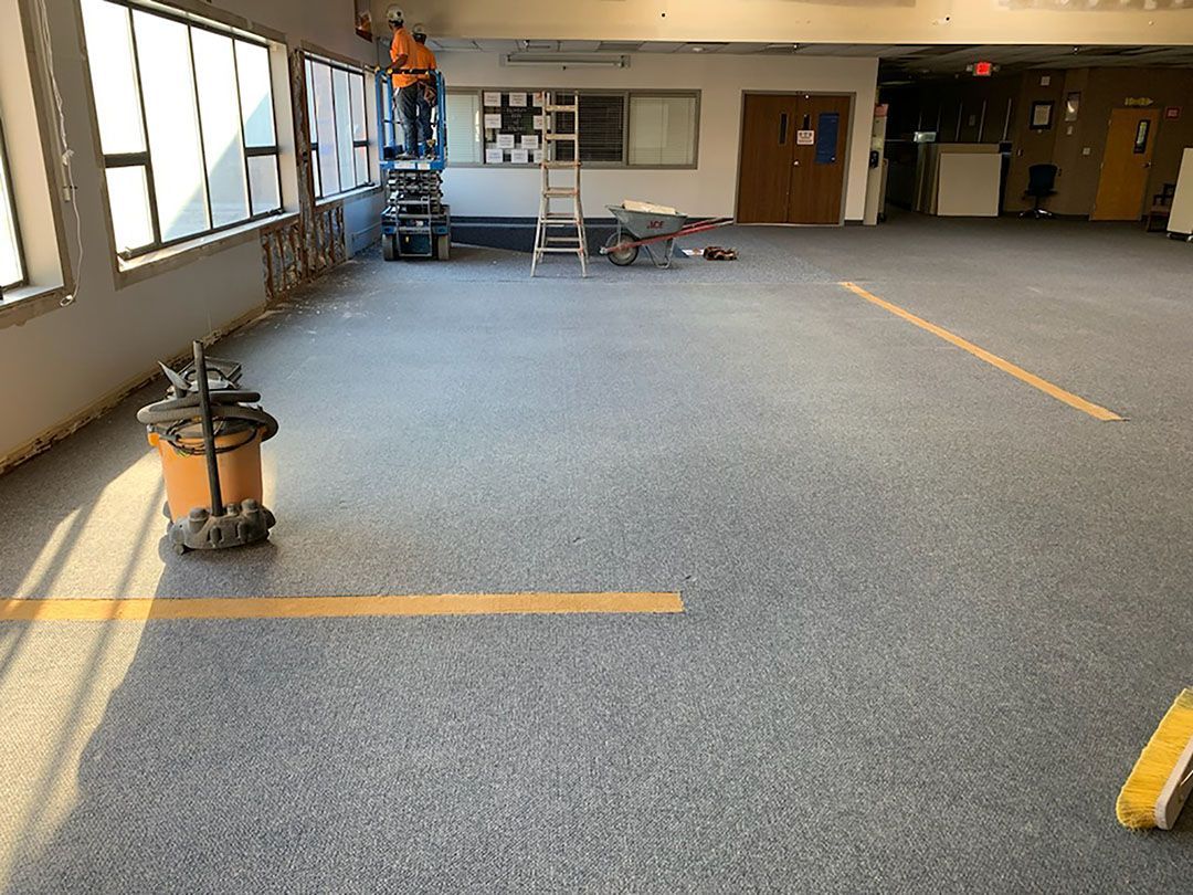 A vacuum cleaner is sitting on the floor of an empty room.