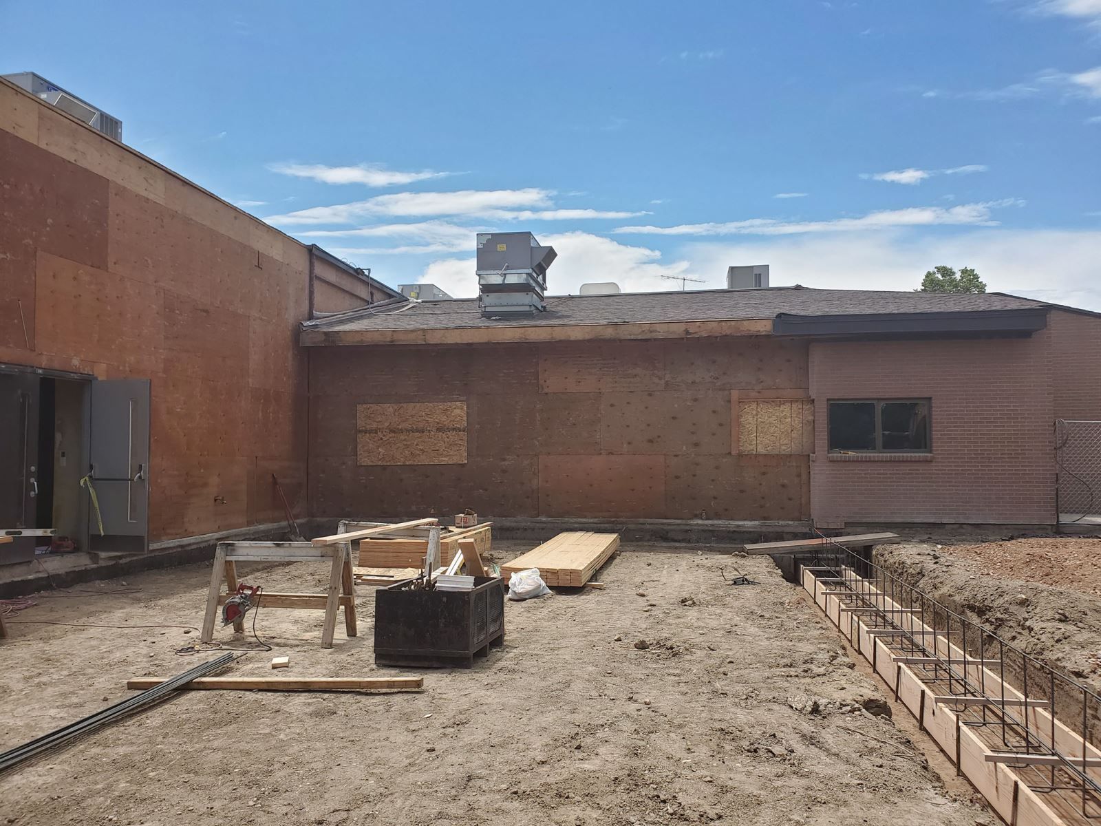 A construction site with a building under construction in the background.