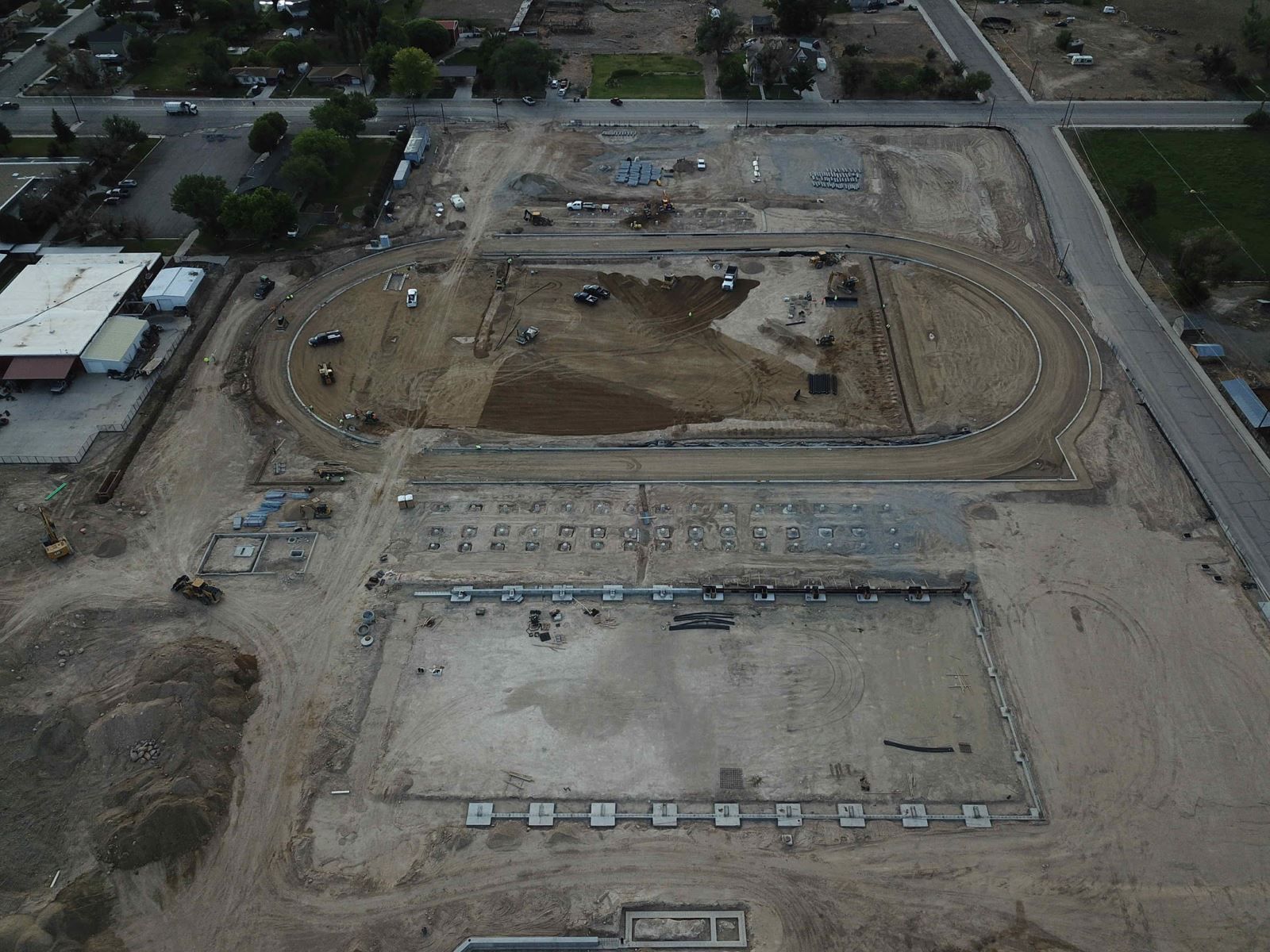 An aerial view of a construction site with a stadium under construction.