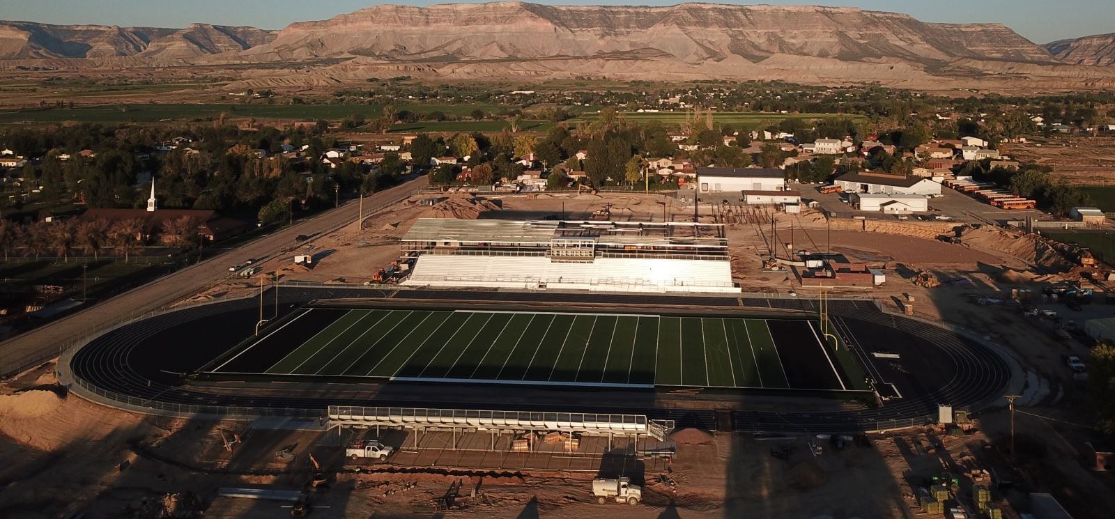 An aerial view of a football stadium with mountains in the background.