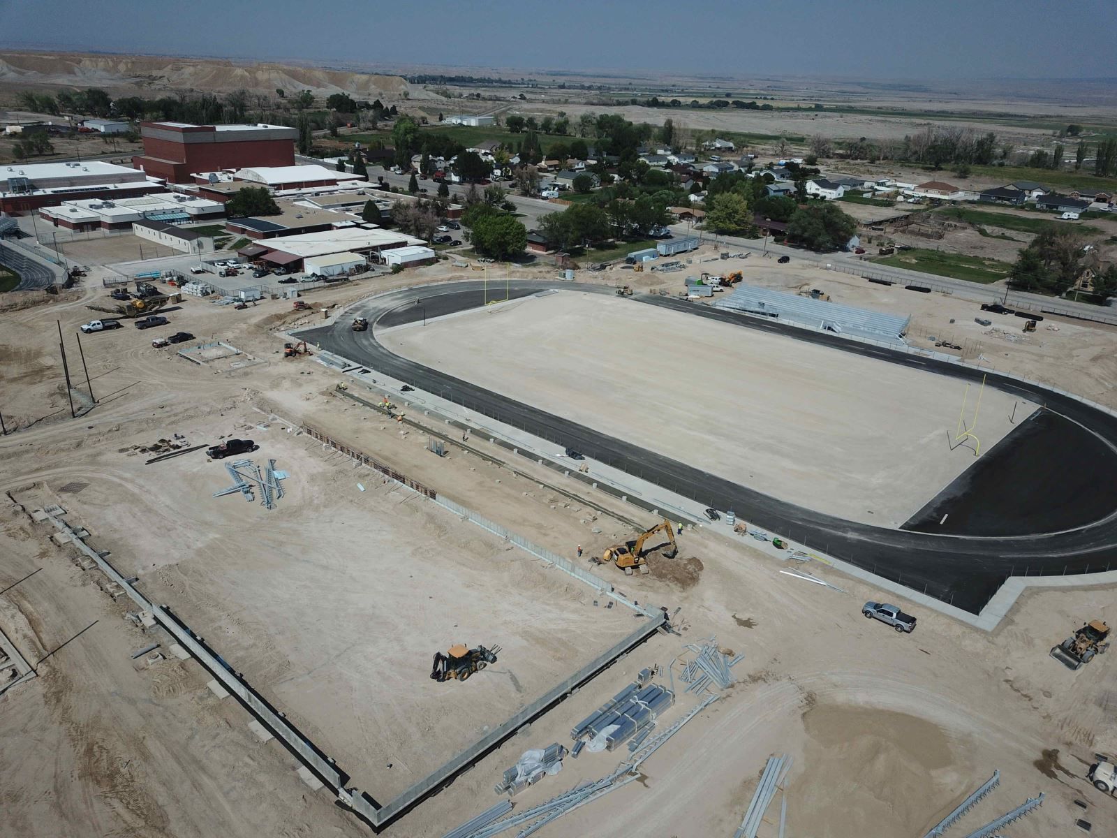 An aerial view of a stadium under construction in the desert