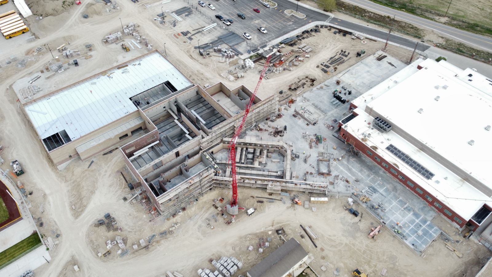 An aerial view of a construction site with a crane in the middle of it.