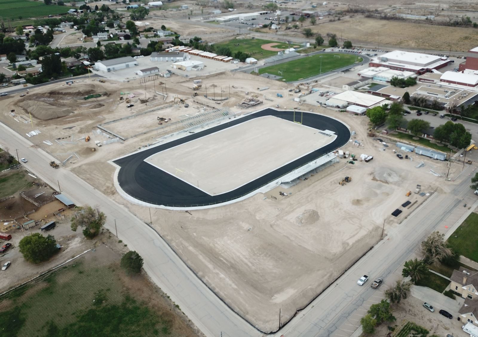 An aerial view of a stadium in the middle of a city