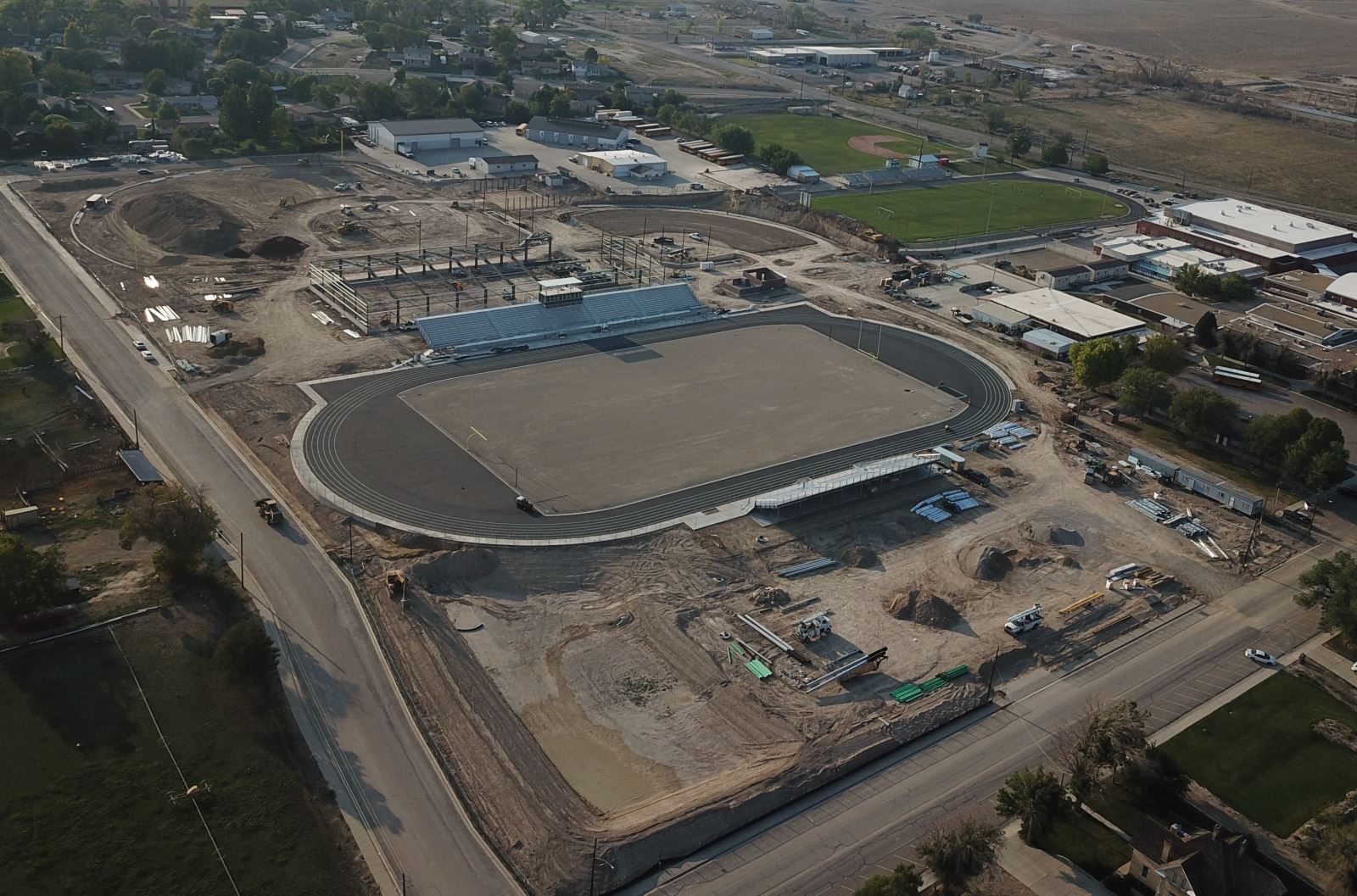 An aerial view of a stadium under construction in a city.