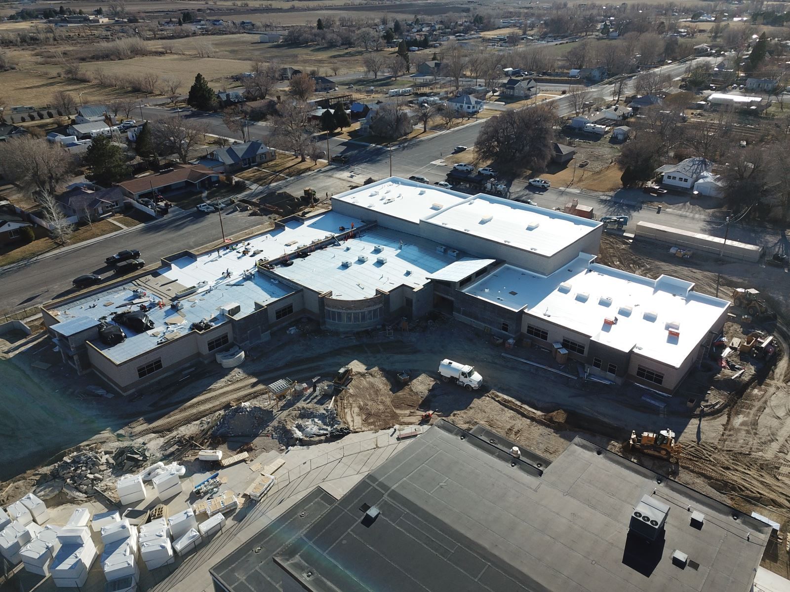 An aerial view of a building under construction in a small town.
