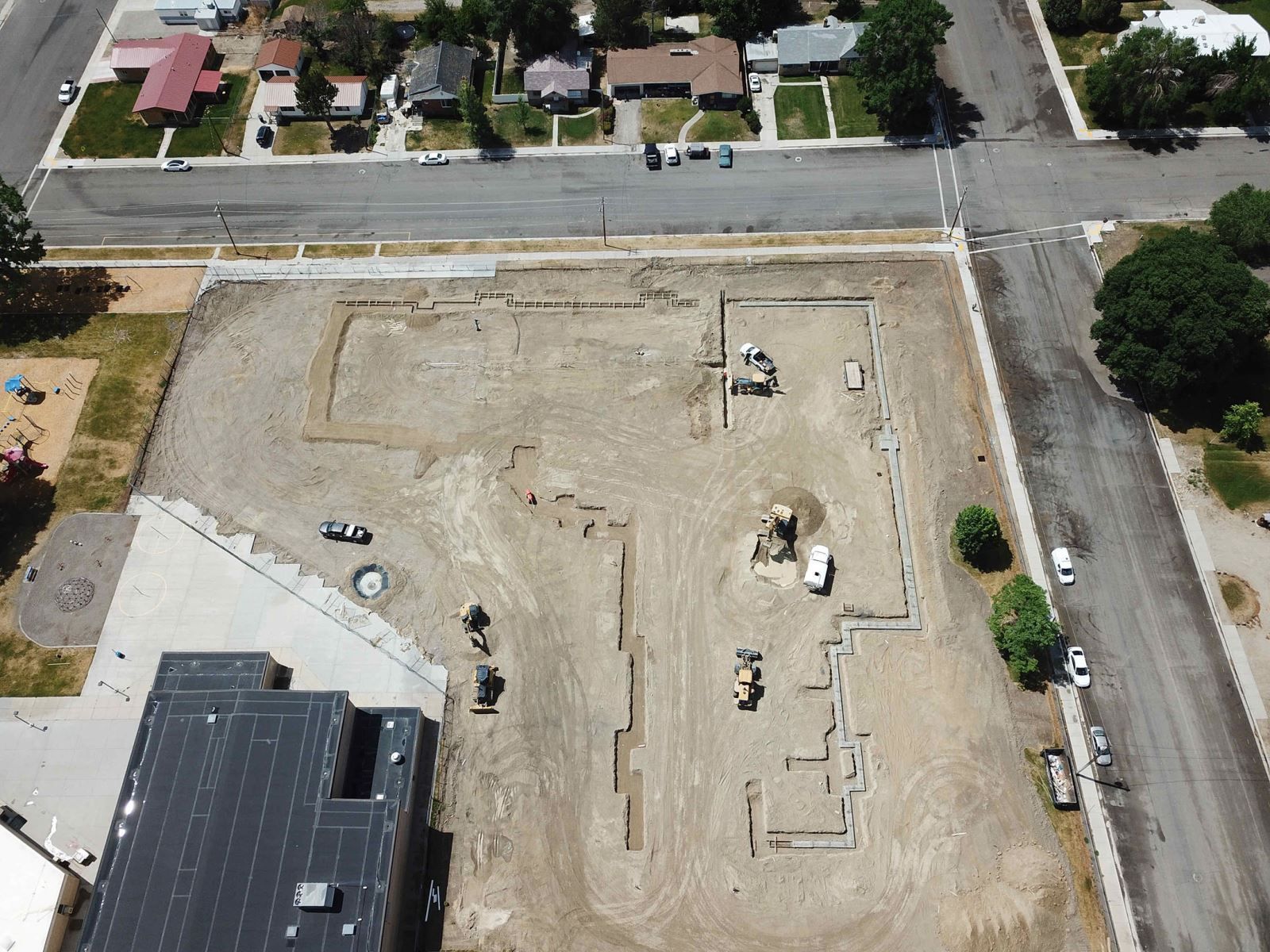 An aerial view of a construction site in a residential area