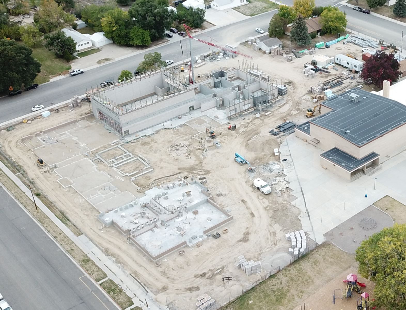 An aerial view of a building under construction in a residential area.