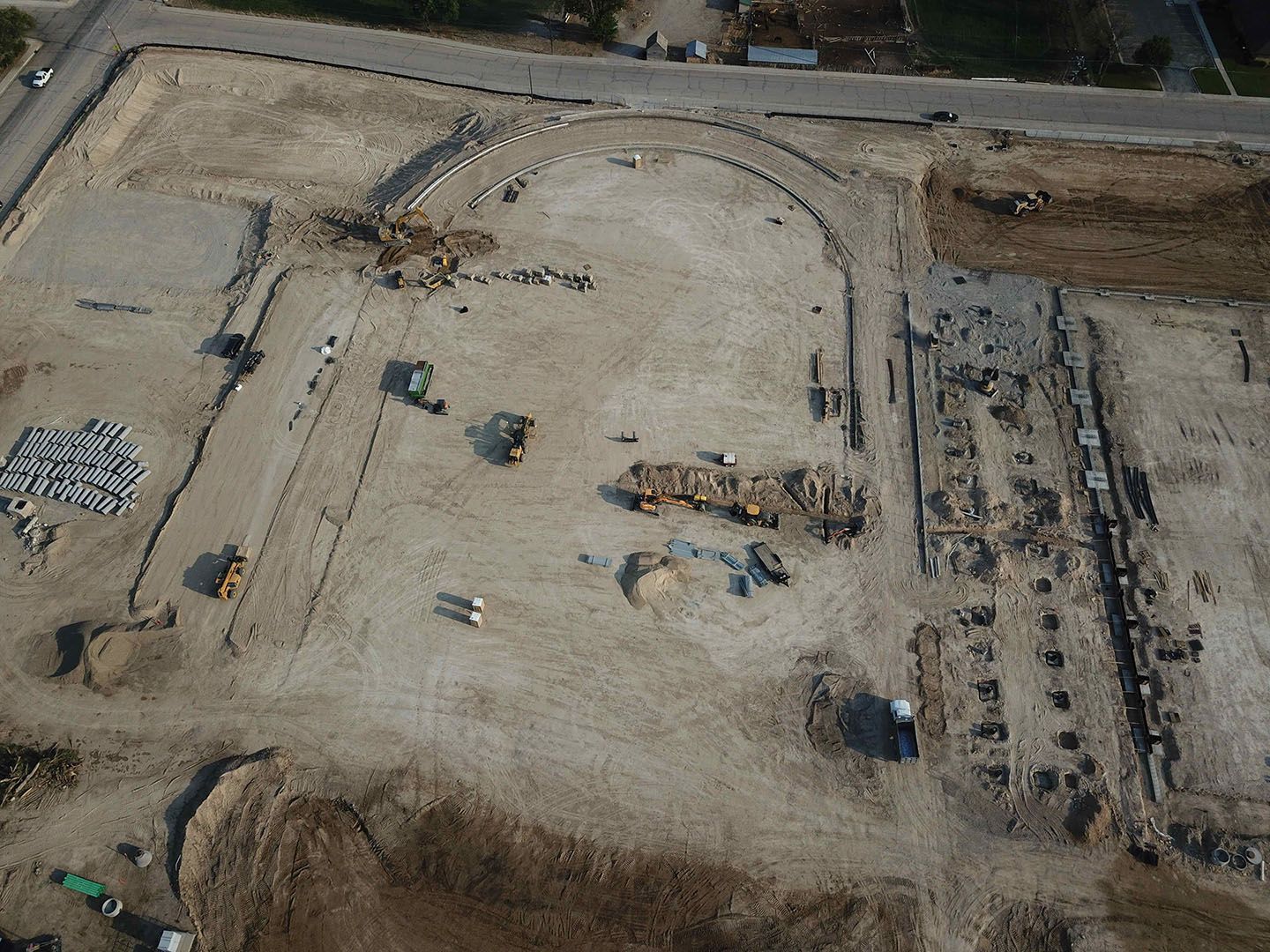 An aerial view of a construction site with a lot of dirt and machinery.