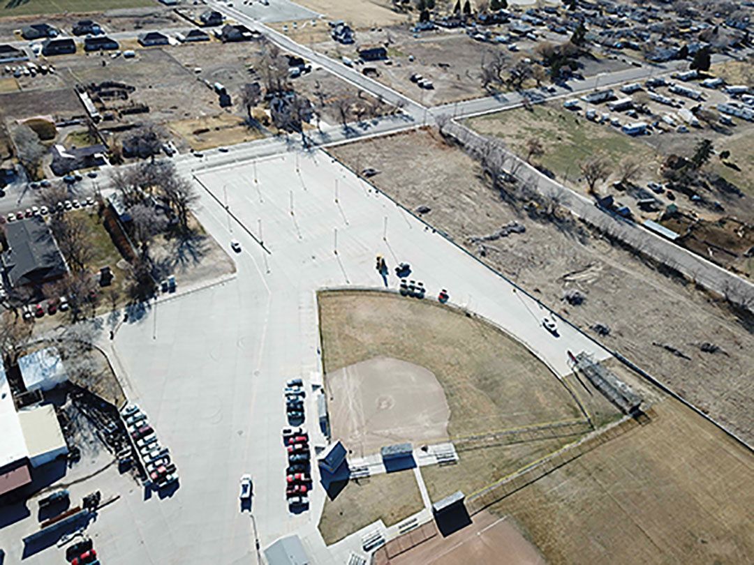 An aerial view of a baseball field in a small town.
