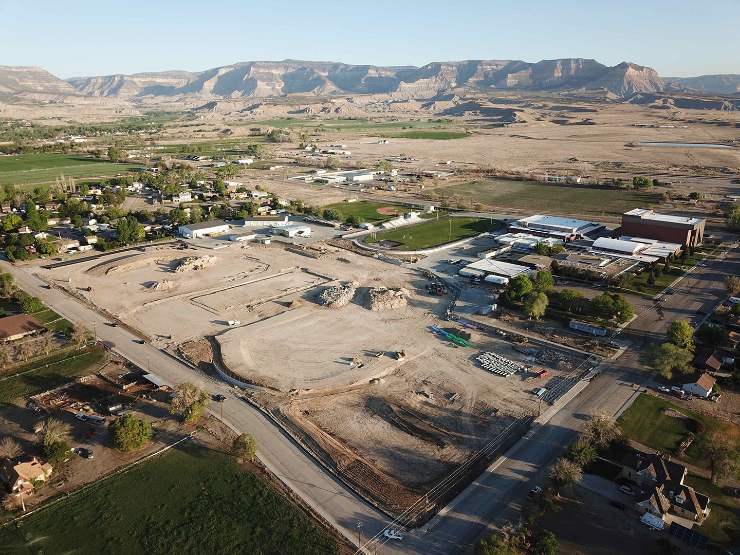 An aerial view of a residential area with mountains in the background.