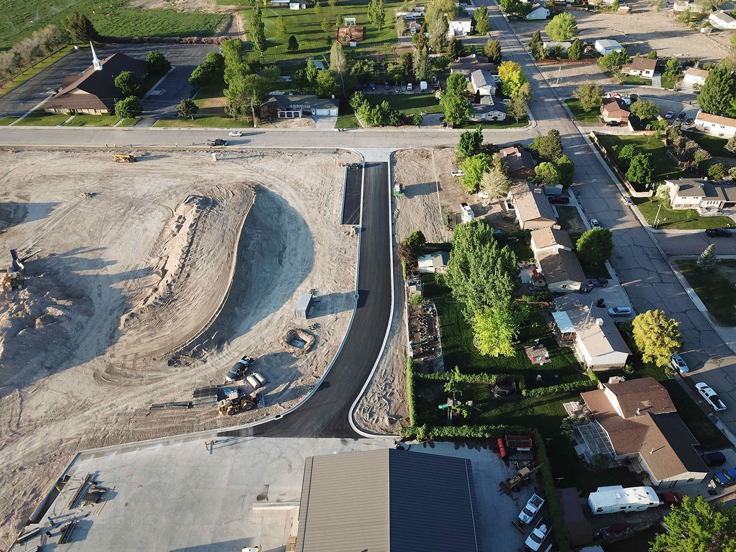 An aerial view of a construction site in a residential area.