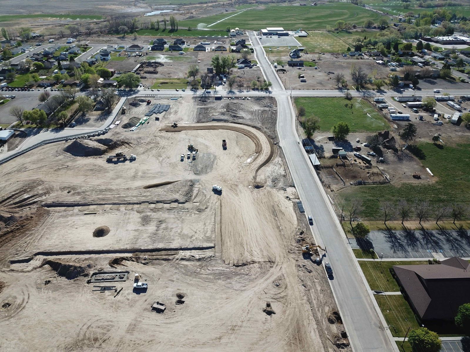 An aerial view of a construction site with a road going through it.