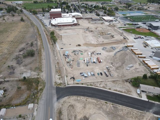 An aerial view of a construction site with a road going through it