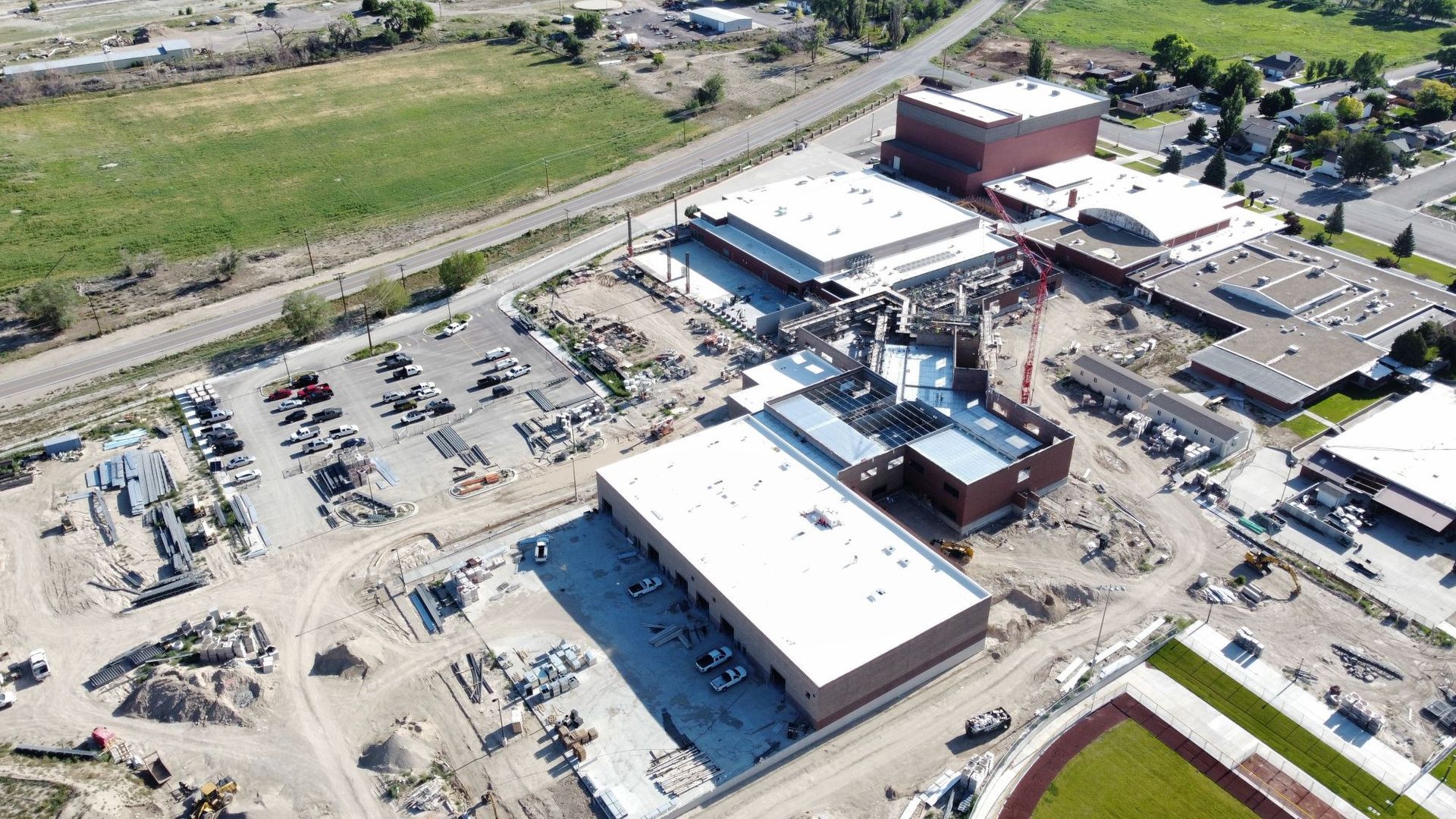 An aerial view of a building under construction in a city.