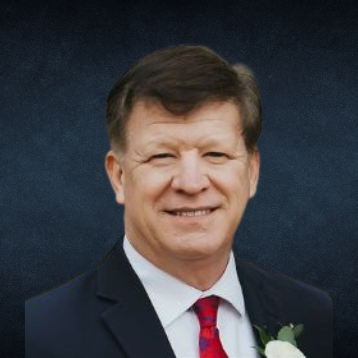 A man with a beard is wearing a suit and tie.