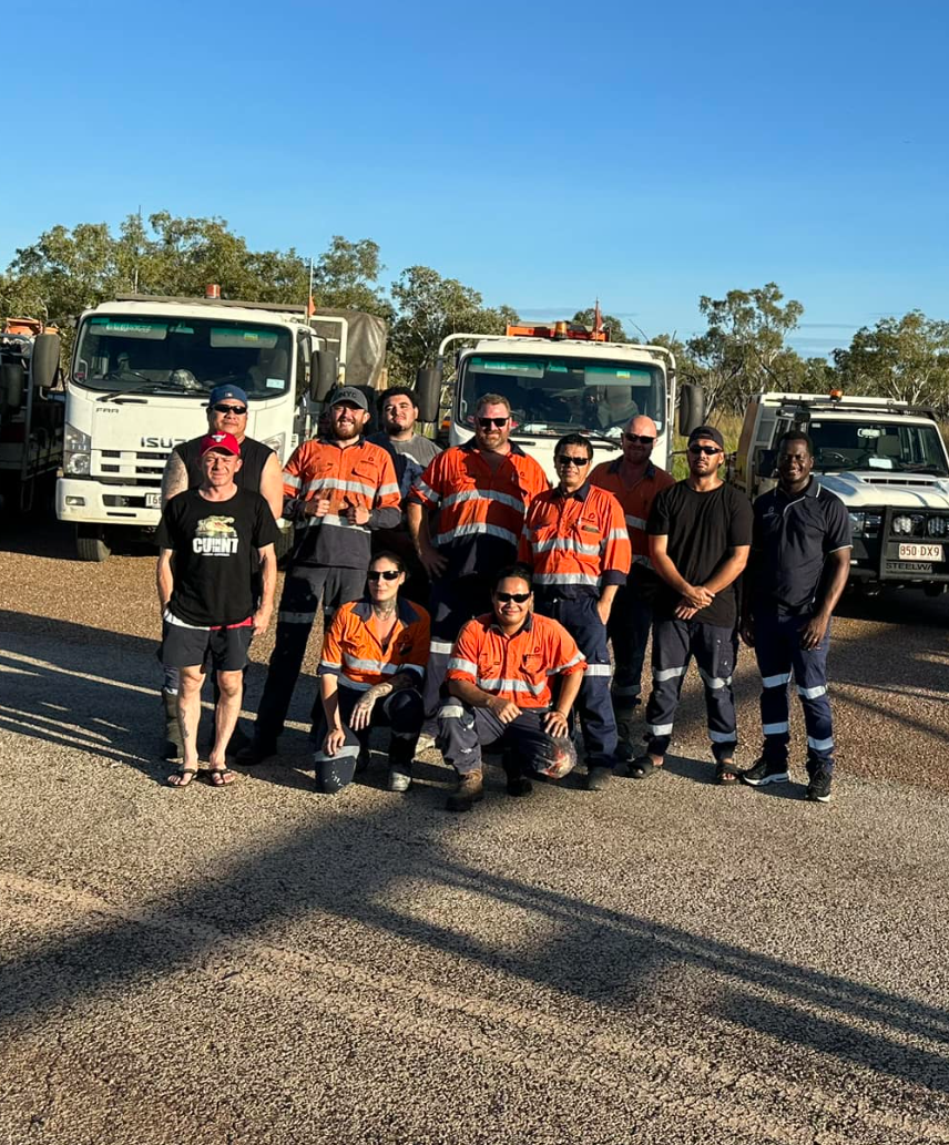 A Man Wearing A Green Helmet Is Holding A Hose — Procoat QLD in Ryan, QLD