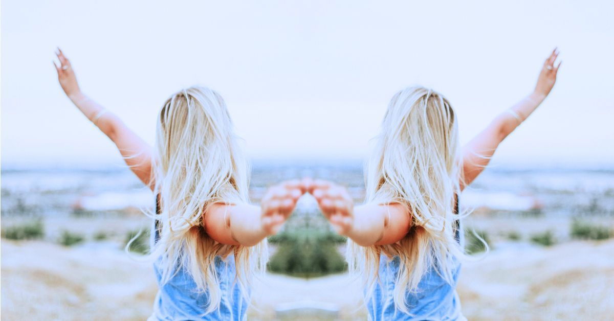 2 women with back to the camera waving