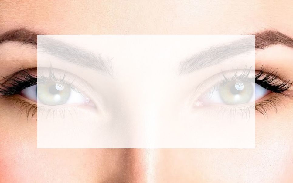 A close up of a woman 's eyes with a white frame around them.