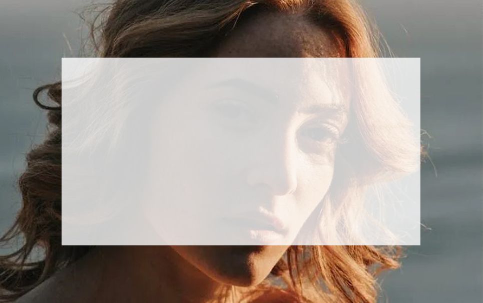 A close up of a woman 's face with a white frame around it.