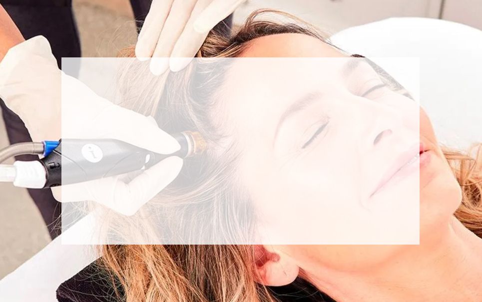A woman is getting a hair treatment at a salon.