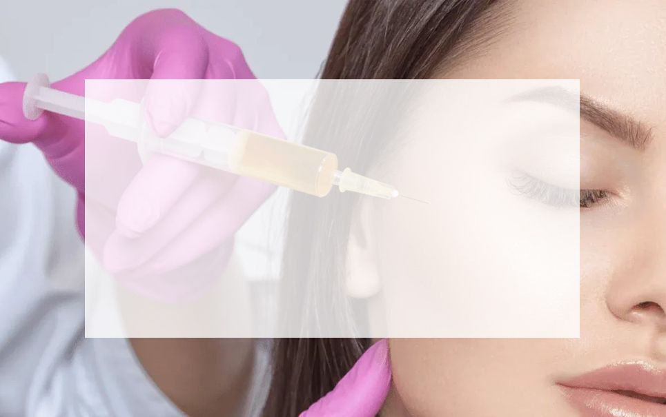 A woman is getting a botox injection in her face.