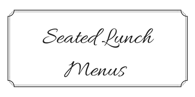 Decorative sign reading “Seated Lunch Menus” in cursive inside a bordered white frame.