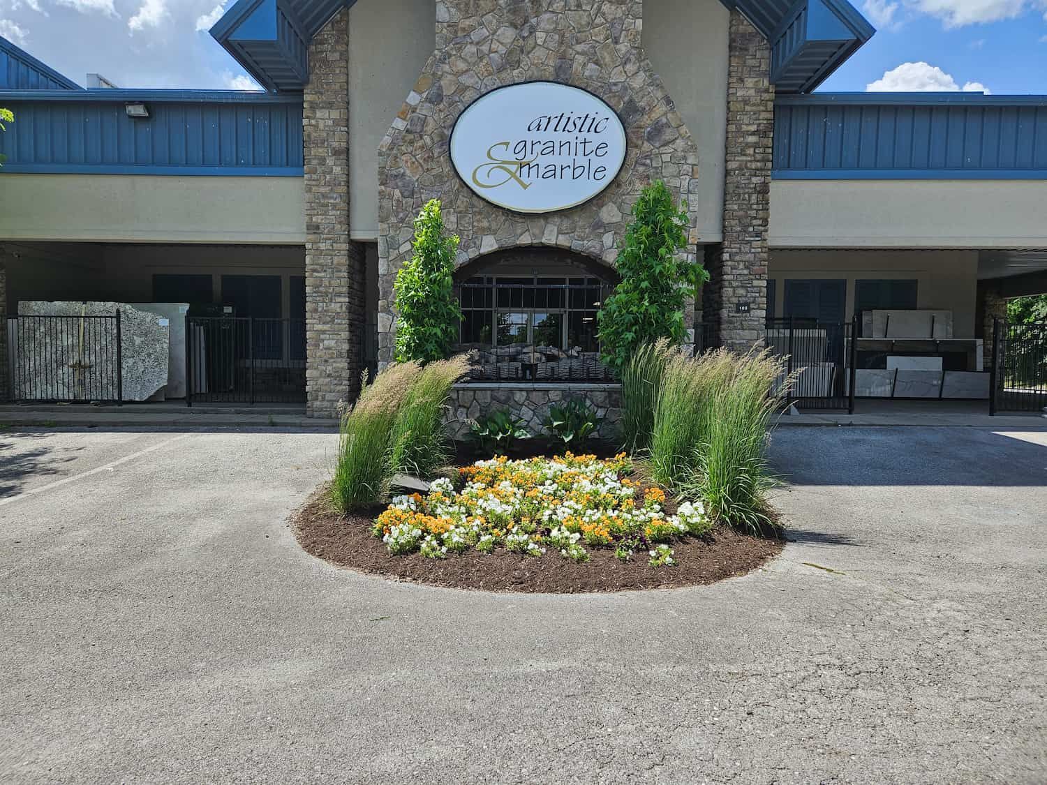 The front of a building with flowers in front of it.