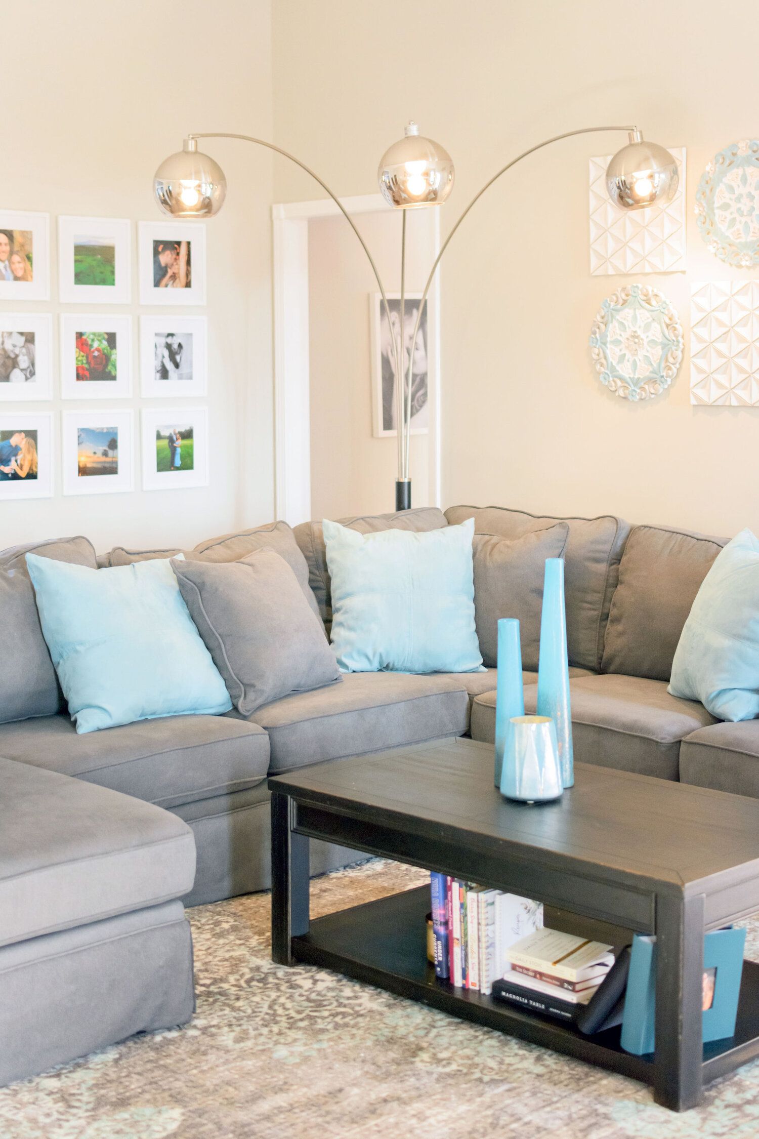 A living room with a sectional couch and a coffee table
