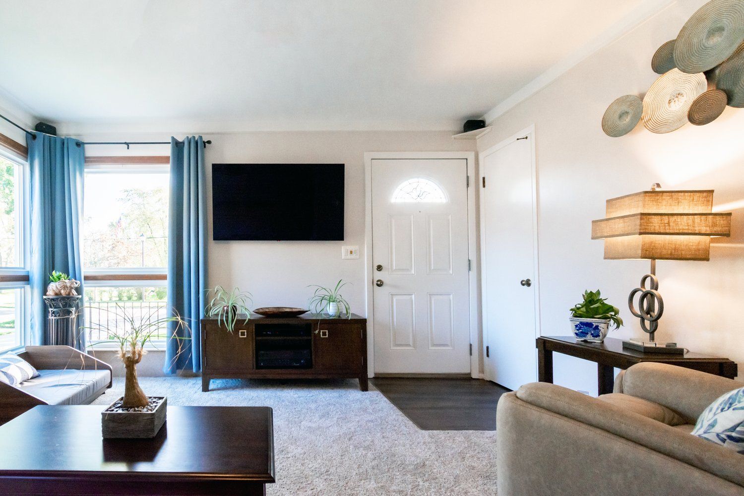 A living room with a flat screen tv on the wall.