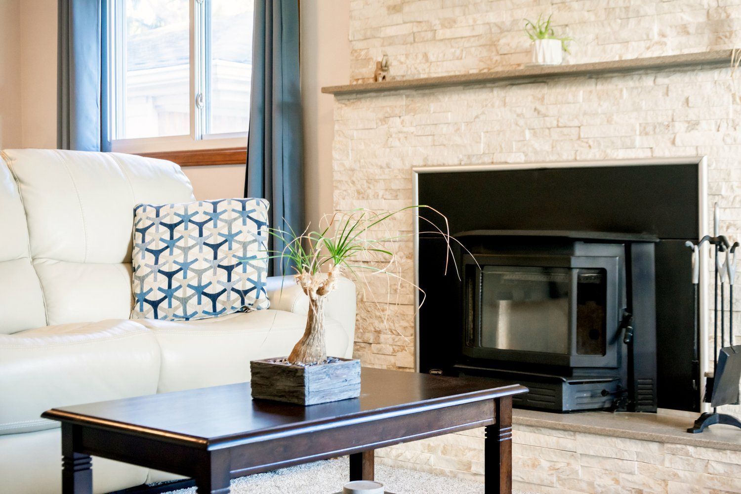 A living room with a fireplace and a coffee table.