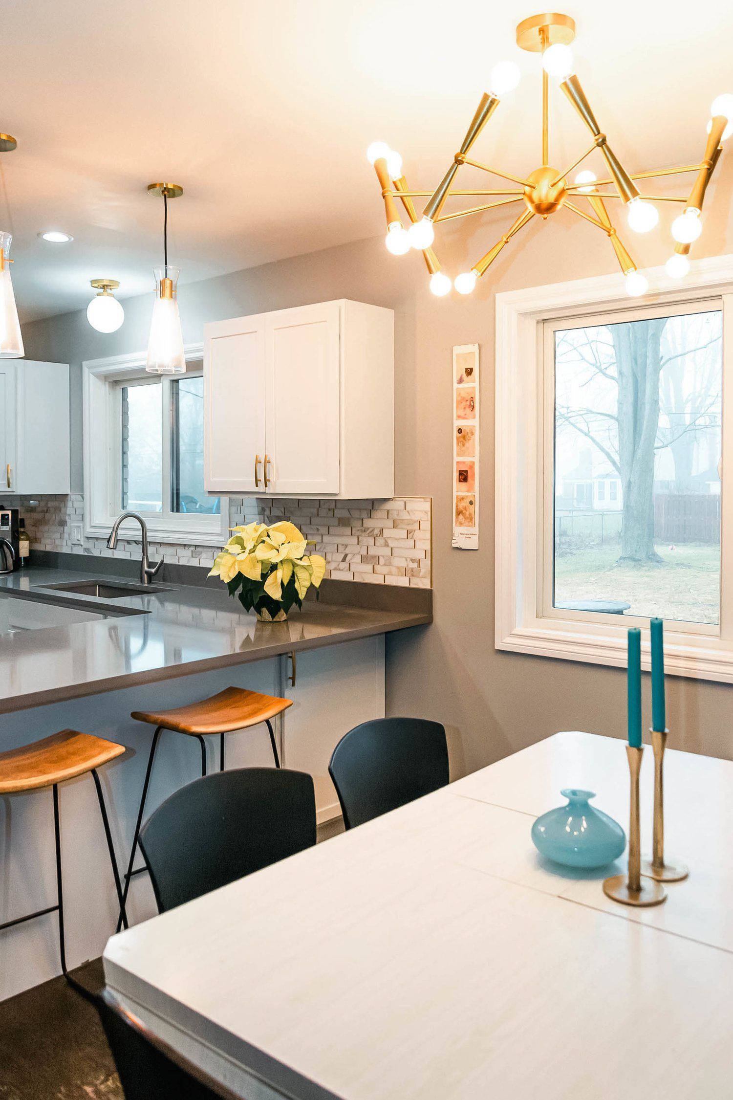 A kitchen with a table and chairs and a window.