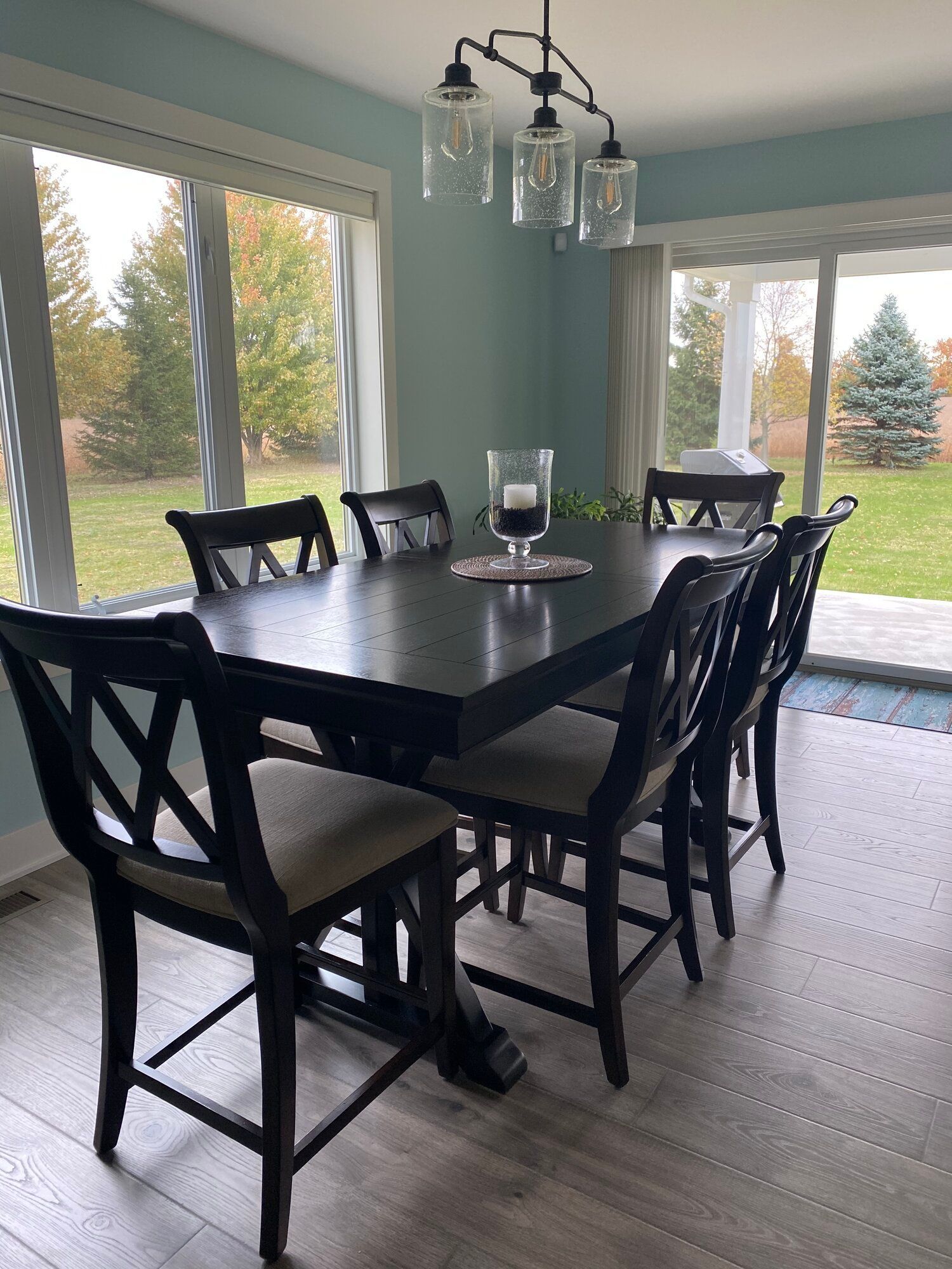 A dining room with a table and chairs and a chandelier.