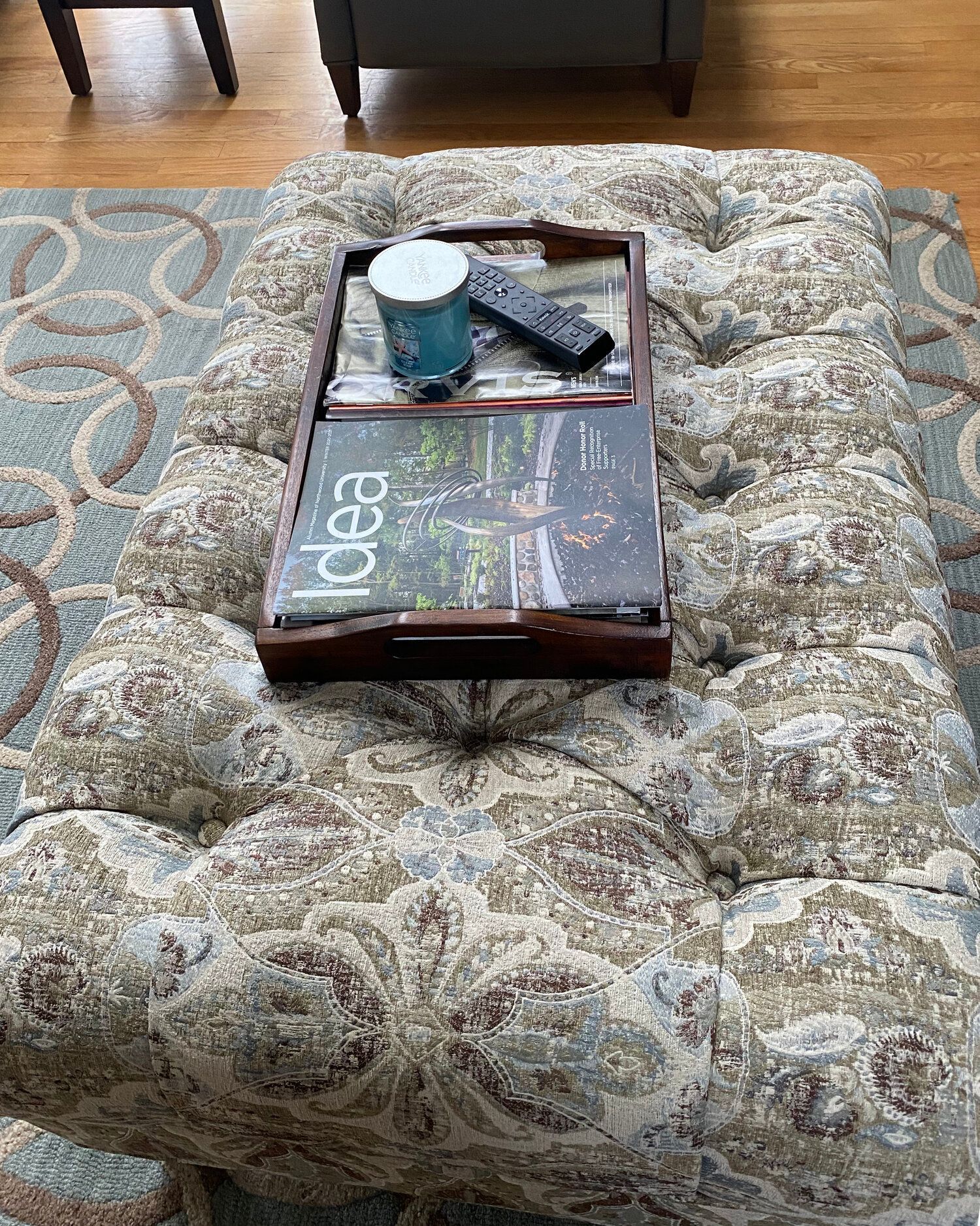 A coffee table with a magazine and a remote control on it.