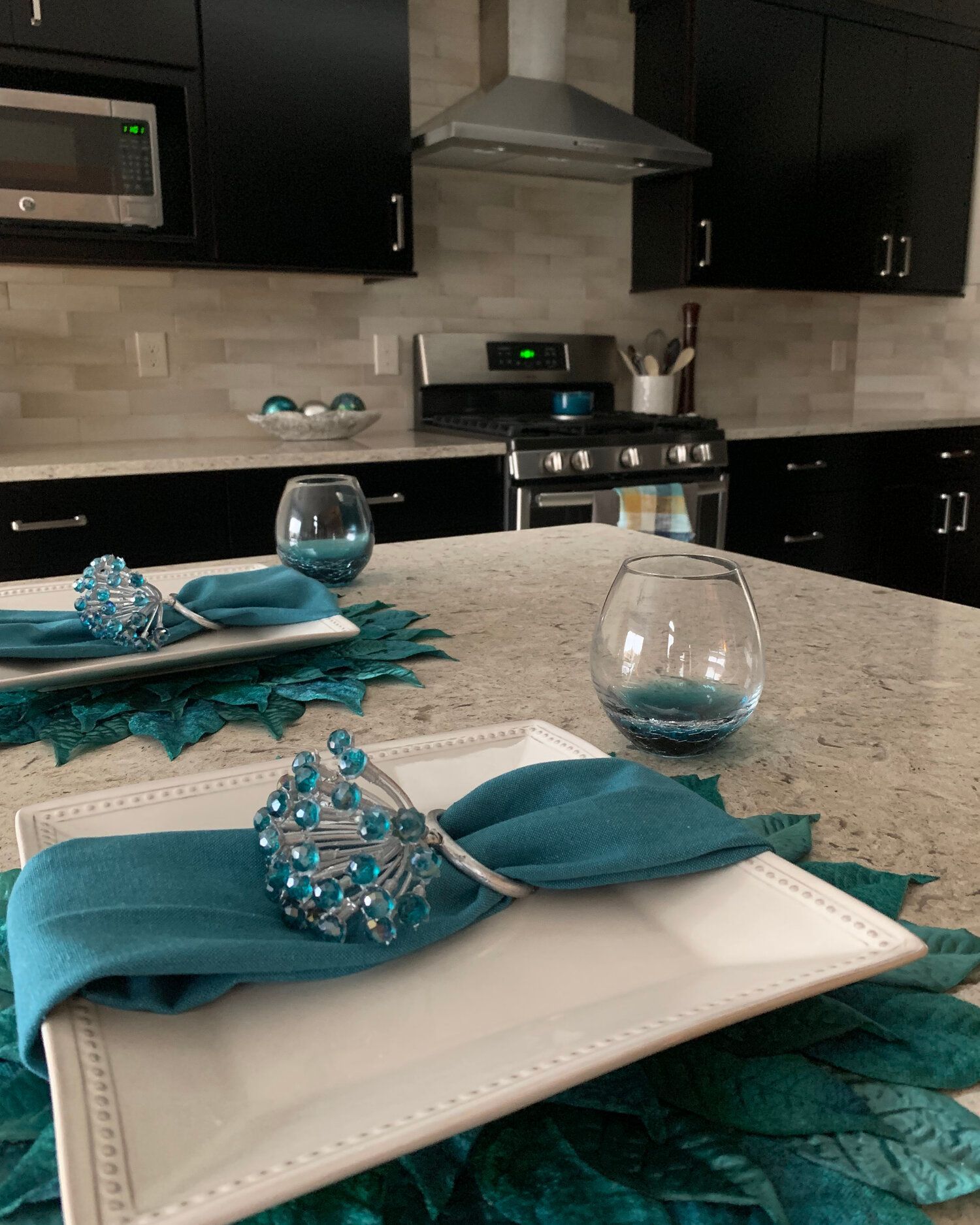 A kitchen counter with plates and napkins on it