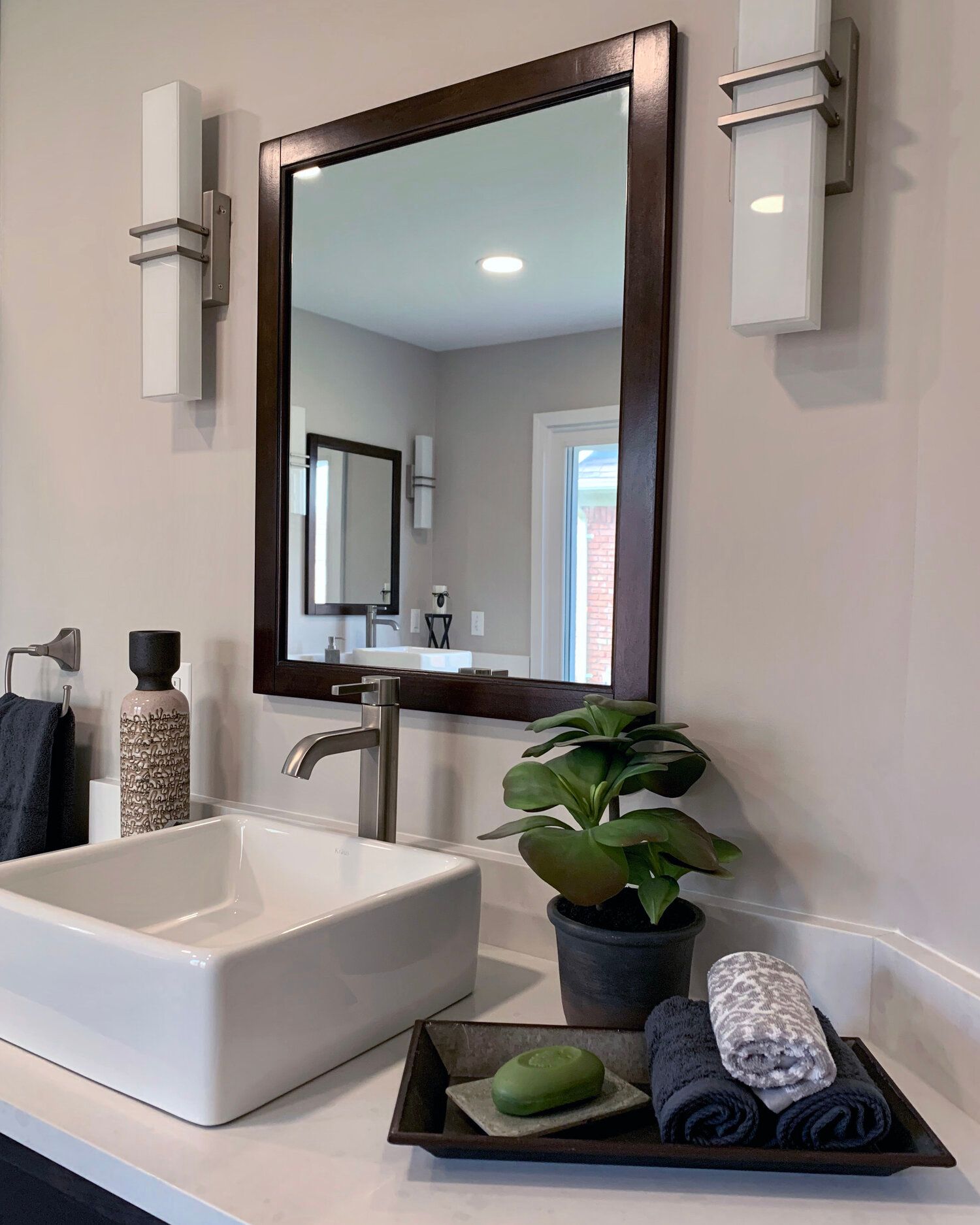 A bathroom with a sink and a mirror on the wall